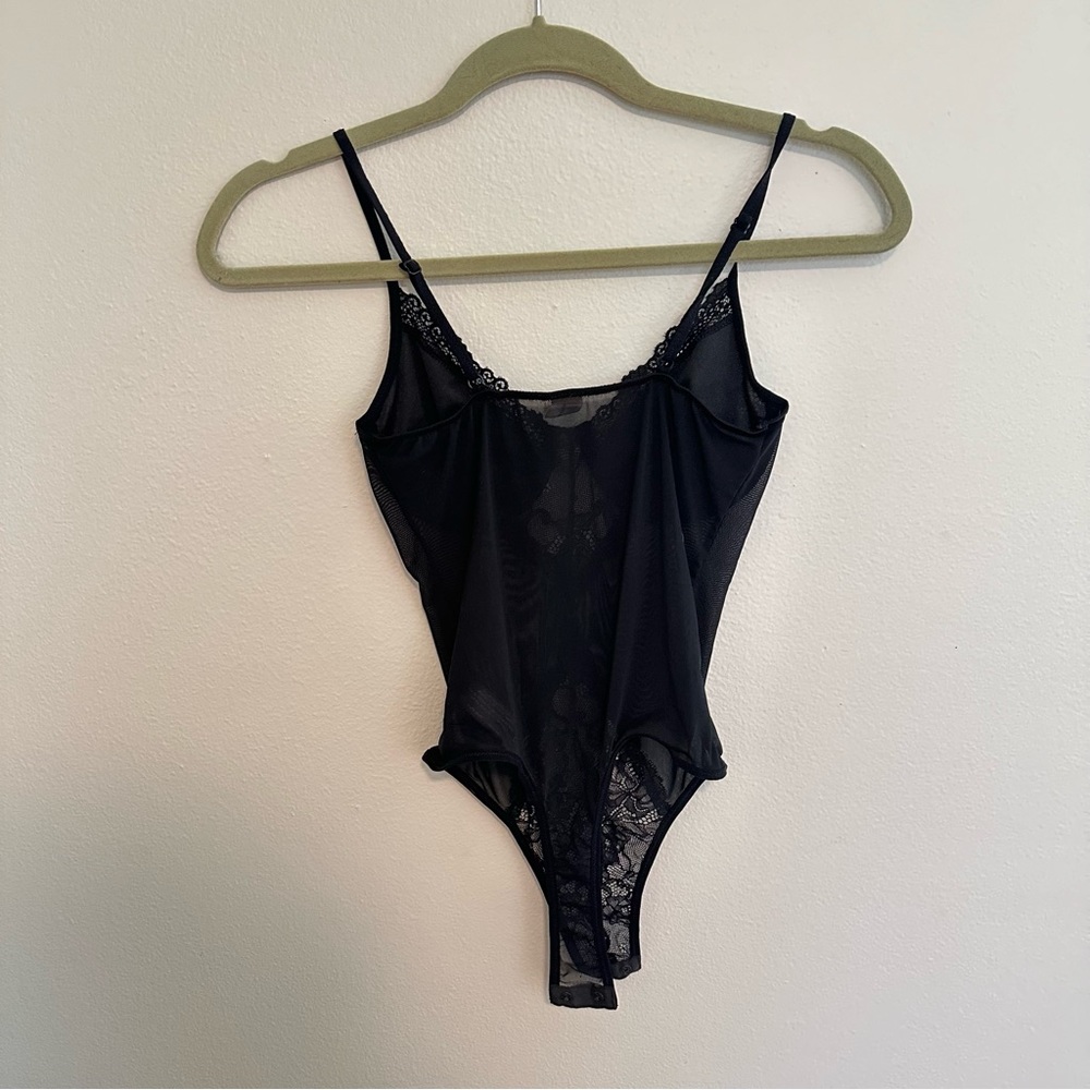 Super cute black lace/mesh body suit never worn. Size S
